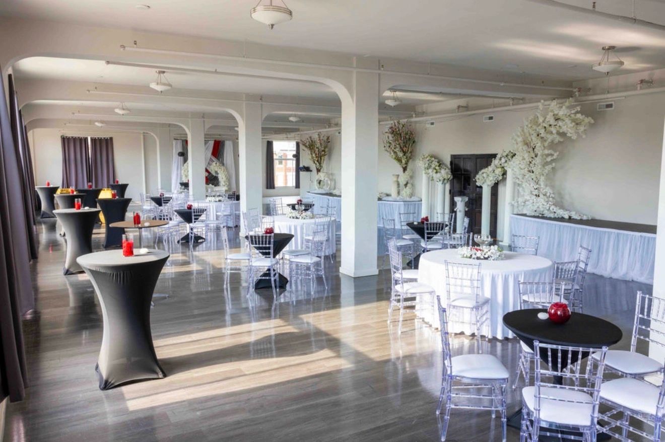 The Kercheval Gallery set with round tables and white chairs